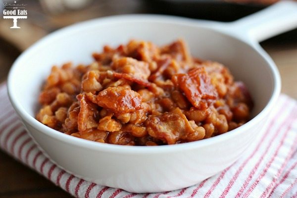 white dish full of bacon baked beans