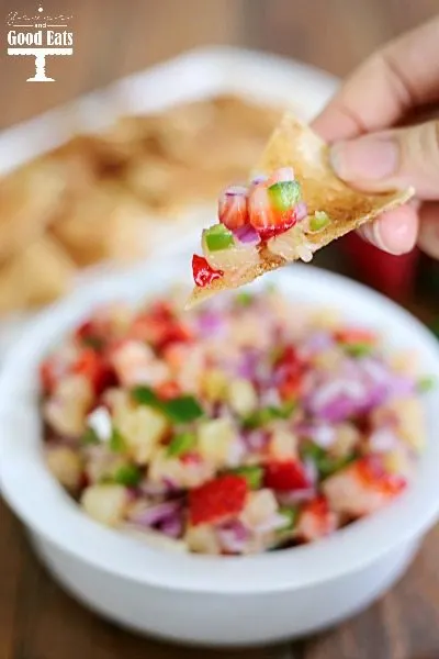 closeup of a cinnamon chip with a scoop of fruit salsa