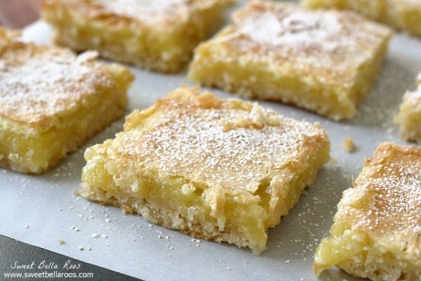 lemon bars cut into squares and dusted with powdered sugar