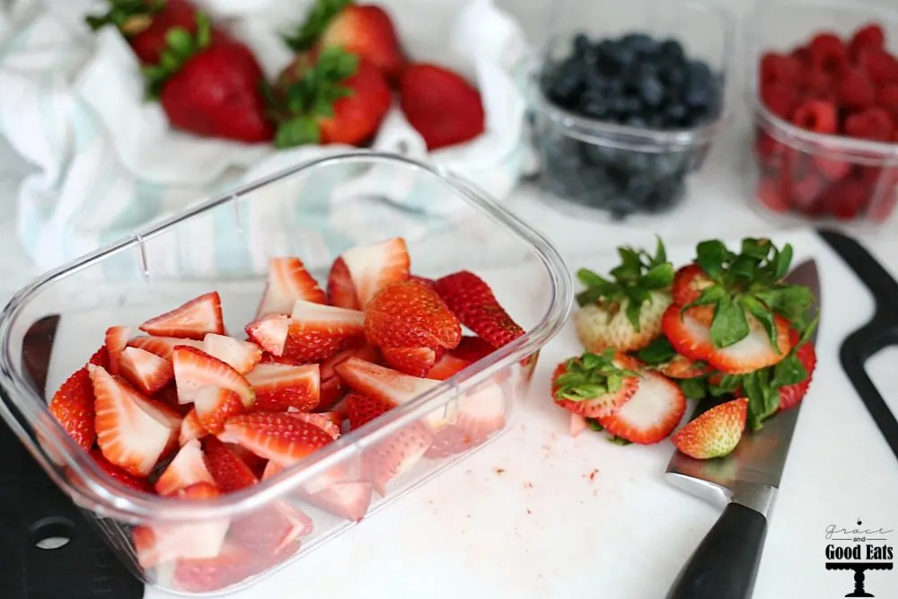 sliced strawberries in clear food storage container 