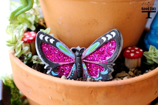 How to make your own DIY Fairy Garden with items from the dollar store! I wanted to make a fairy garden with my kids and we found tons of cute supplies (for cheap!) at the dollar store. Such an easy and fun outdoor garden craft for kids.