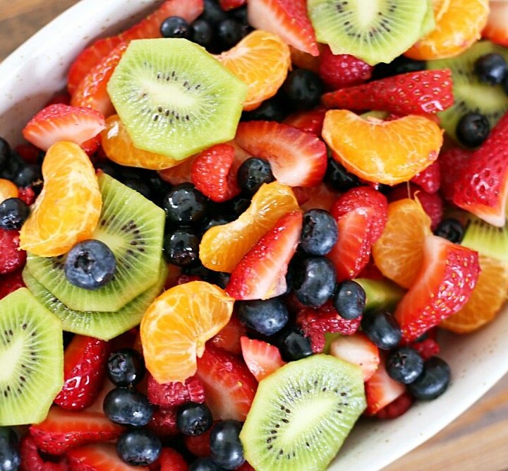 This fruit salad with honey lime dressing is the only recipe you need for all of your summer celebrations! It is my go-to recipe when I need to bring something to a BBQ or picnic. Fresh, colorful berries paired perfectly with a honey lime glaze you will want to eat with a spoon.