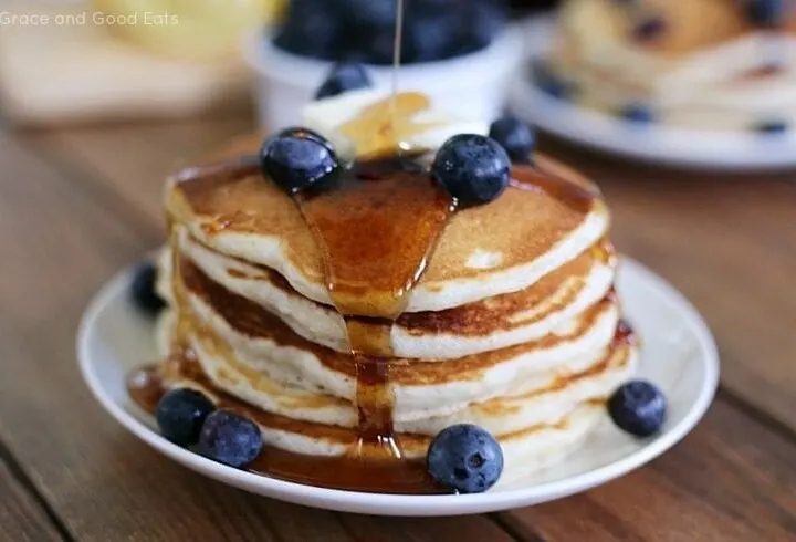 blueberry pancakes topped with butter and syrup