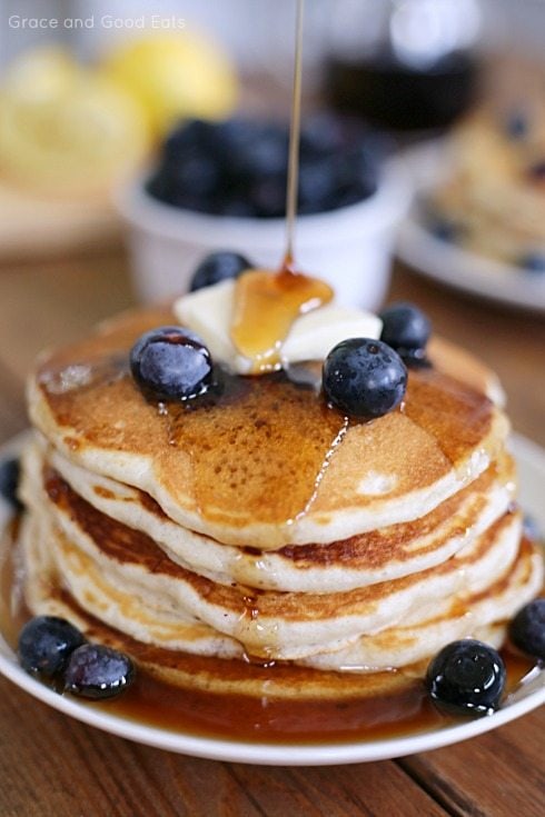 Stack of pancakes with syrup cascading down the sides