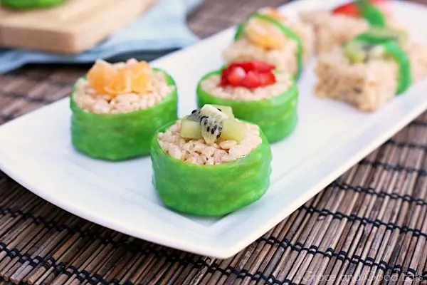 fruit sushi treats wrapped in fruit leather and topped with fresh kiwi