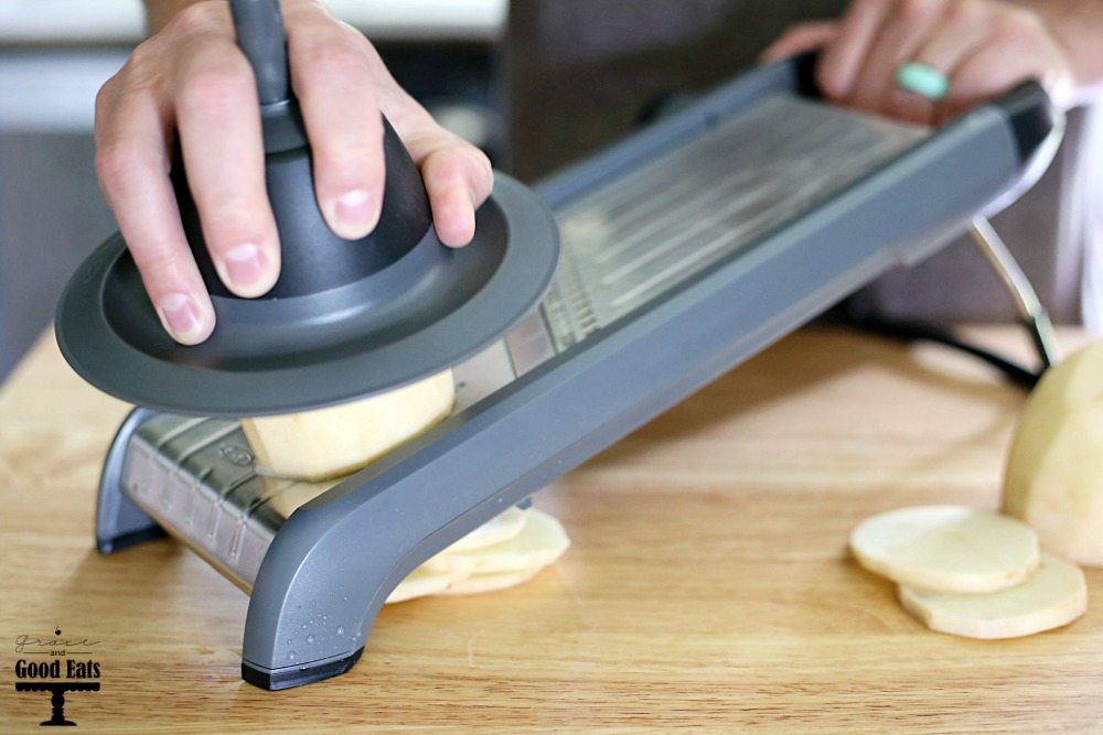 man demonstrating how to thinly slice potatoes with the OXO Mandoline