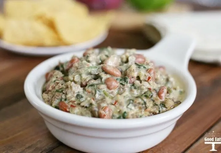 This Sausage and Bean Spinach Dip is a hearty appetizer full of spicy pork sausage and pinto beans. Serve warm for a delicious creamy dip with corn chips, pretzel rods, or bell pepper strips.