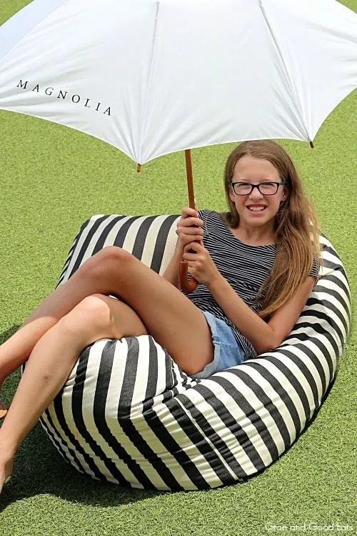 girl sitting on a black and white stripped bean bag chair
