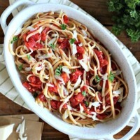 pasta dish with tomatoes, shaved parmesan, and linguine noodles