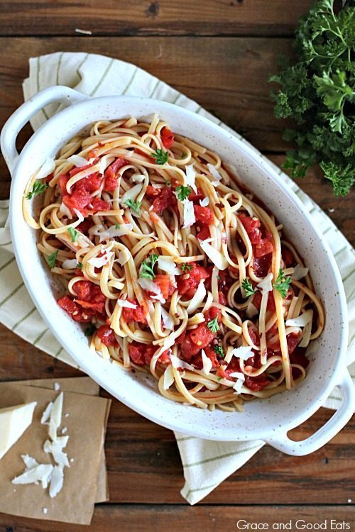 pasta dish with tomatoes, shaved parmesan, and linguine noodles