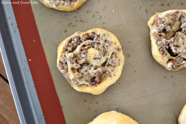 two sausage cream cheese crescent rolls on a baking tray