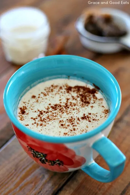 blue mug of chai tea with spices sprinkled on top