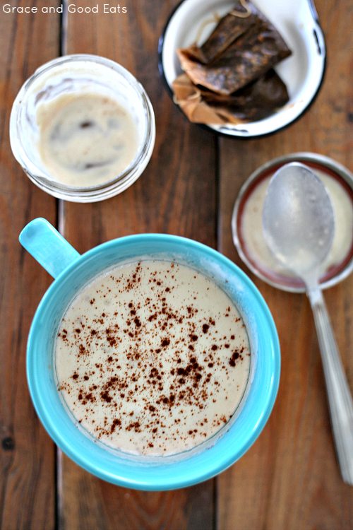 chai tea latte in a blue mug with tea bags in the background