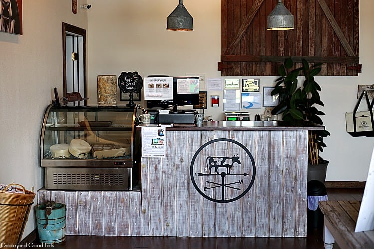 wooden register area with glass case for cheese