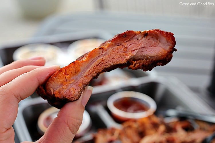 a smoked BBQ rib held between two fingers