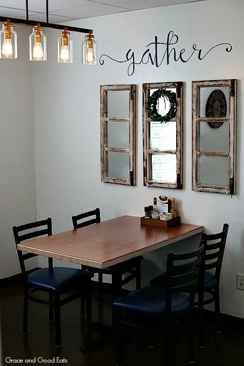 table with four chairs against a wall 