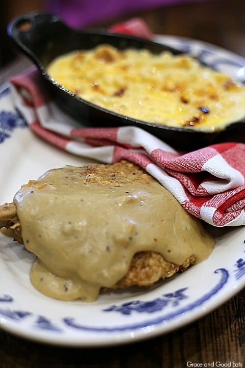 pork chops covered in cream gravy on a plate