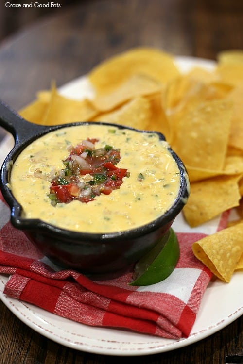 queso topped with pico served in a cast iron skillet