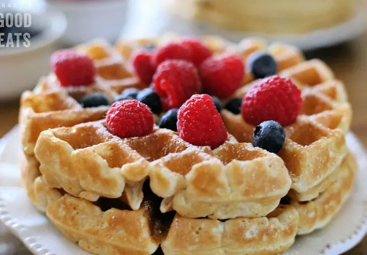 thick waffles topped with blueberries and raspberries