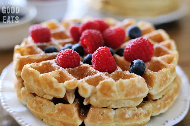 thick homemade waffles topped with blueberries and raspberries
