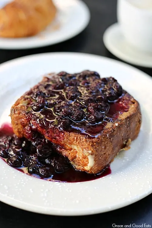 thick slice of stuffed French toast with a generous blueberry compote topping