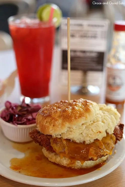 chicken biscuit, purple slaw, and a raspberry limeade on a table