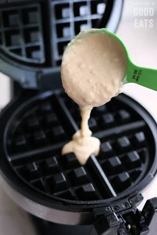 pouring waffle batter into a waffle maker