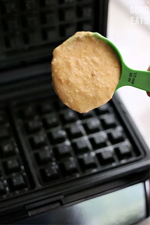 scooping waffle batter onto a hot griddle
