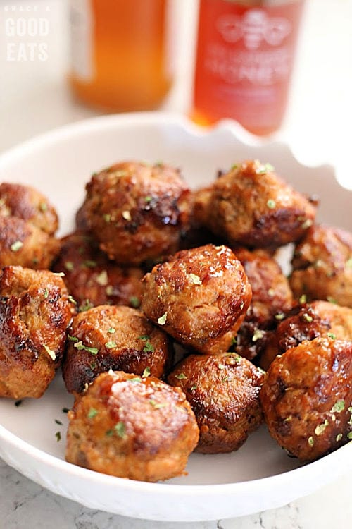 beautifully browned meatballs in a white bowl