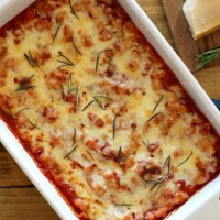 cheesy Italian canned baked beans in a white rectangular dish