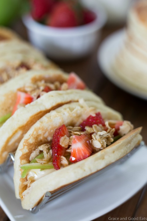 Pancake Parfait Tacos filled with yogurt, granola, apples, and strawberries and topped with a drizzle of honey.  Serve with breakfast potatoes or scrambled eggs for an easy, kid-friendly breakfast!