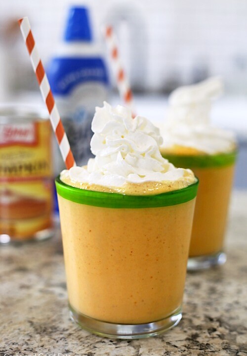 pumpkin smoothie in a glass with whipped cream