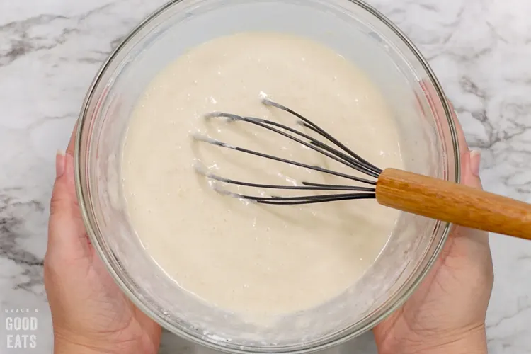 homemade pancake batter with a whisk in the center