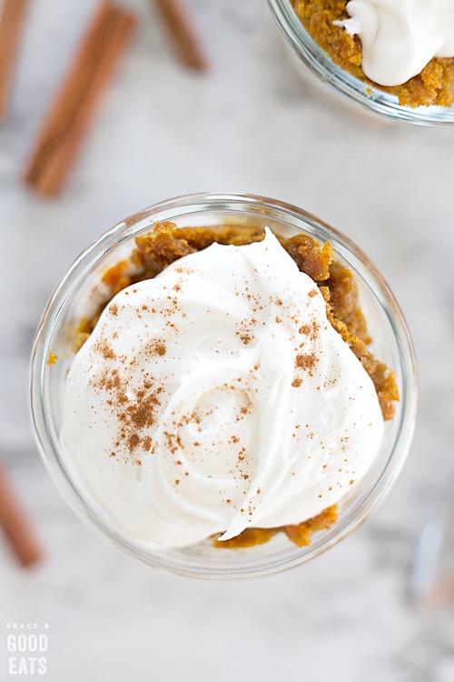 close up of cream cheese frosting atop pumpkin cake sprinkled with cinnamon