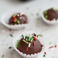 chocolate truffle in a small wrapper with red and green sprinkles