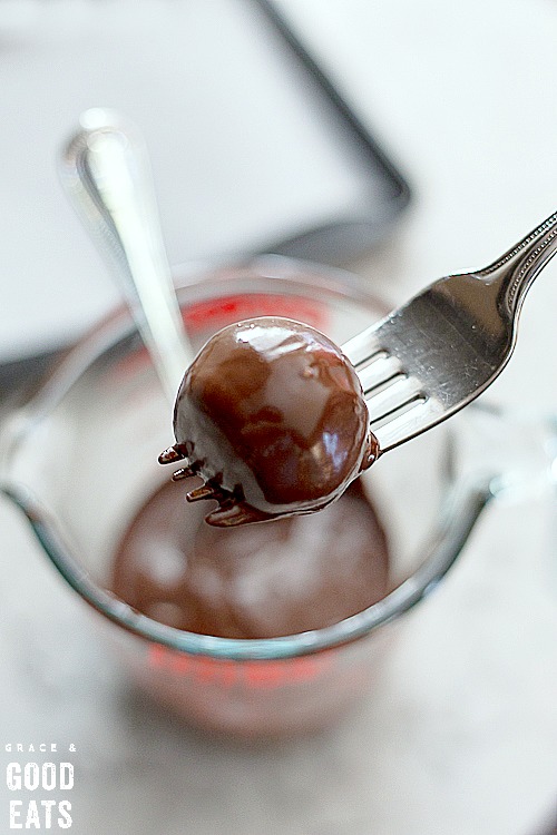 dipping truffles in melted chocolate with a fork