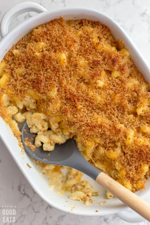 casserole dish of mac and cheese with a big portion scooped out