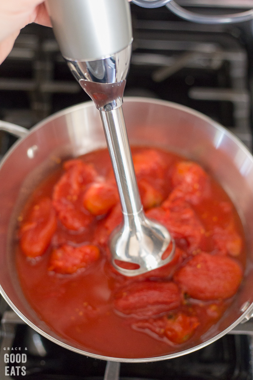 blending whole peeled tomatoes with an immersion blender