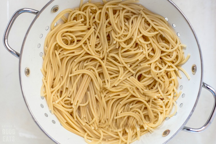 strainer full of spaghetti noodles