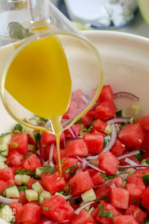 pouring dressing over salad