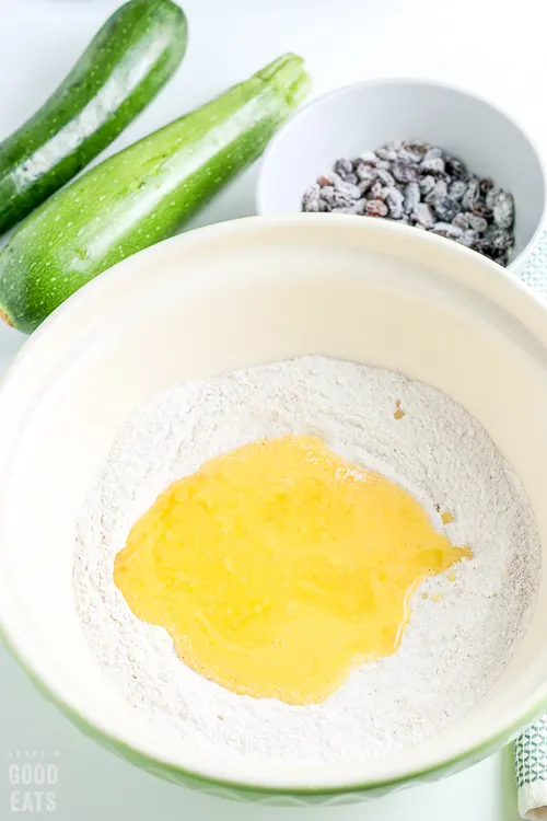 large mixing bowl with flour and eggs