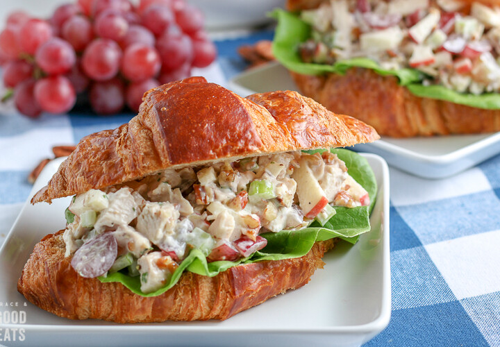 chicken salad sandwich with grapes in the background