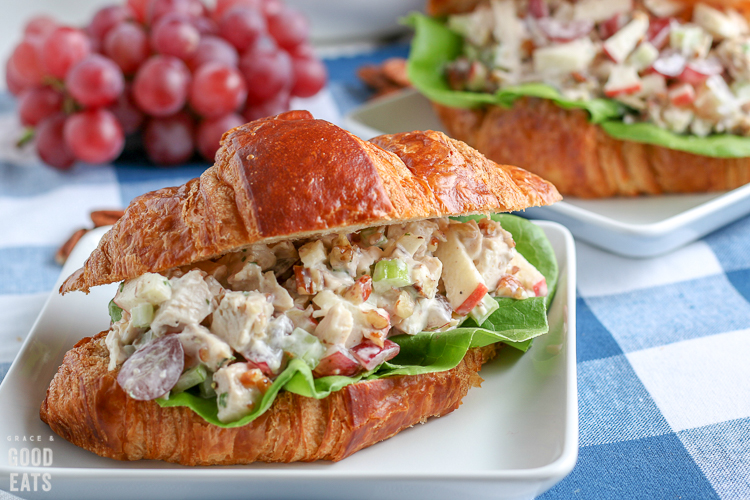 chicken salad sandwich with grapes in the background