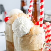 zoomed in view of root beer float in mugs