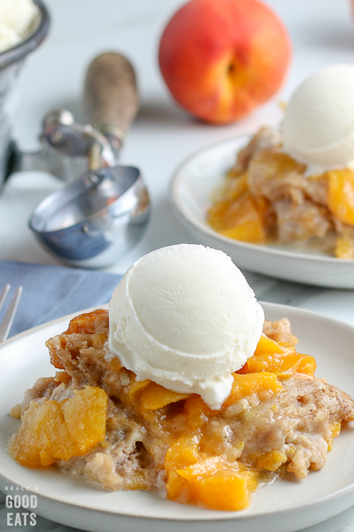 peach cobbler with a scoop of vanilla ice cream