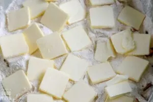 pats of butter atop a flour mixture