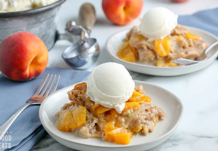 white plate with peach cobbler