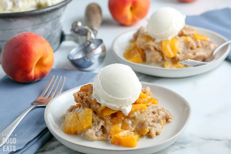 white plate with peach cobbler