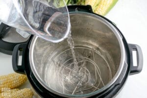 pouring water in a pressure cooker