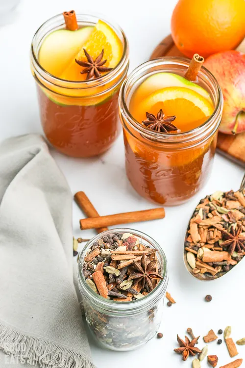 jar of mulling spices next to mulled cider